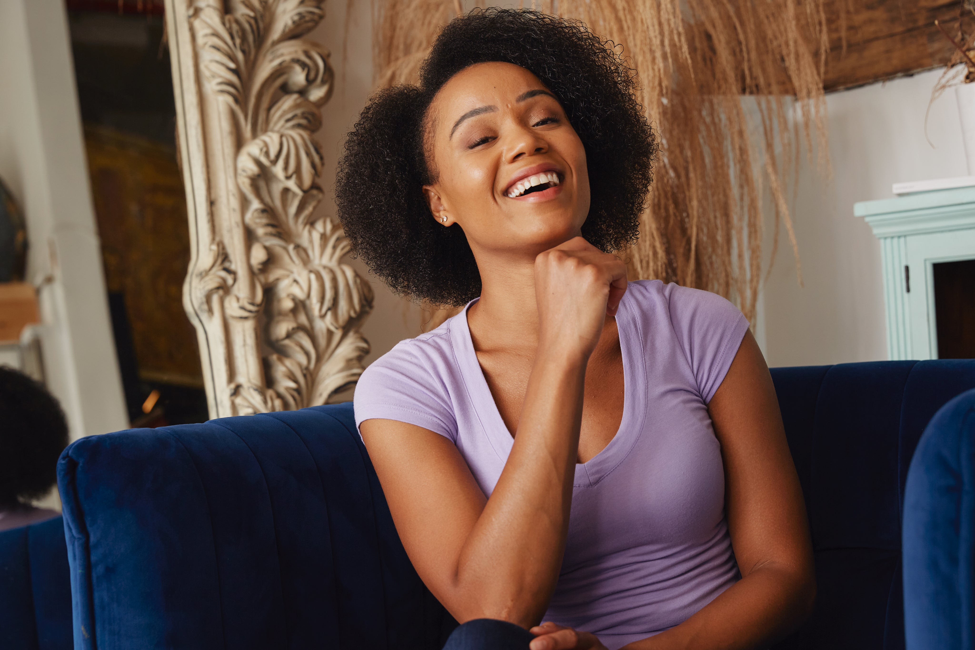 files/female-model-smiles-in-blue-chair.jpg